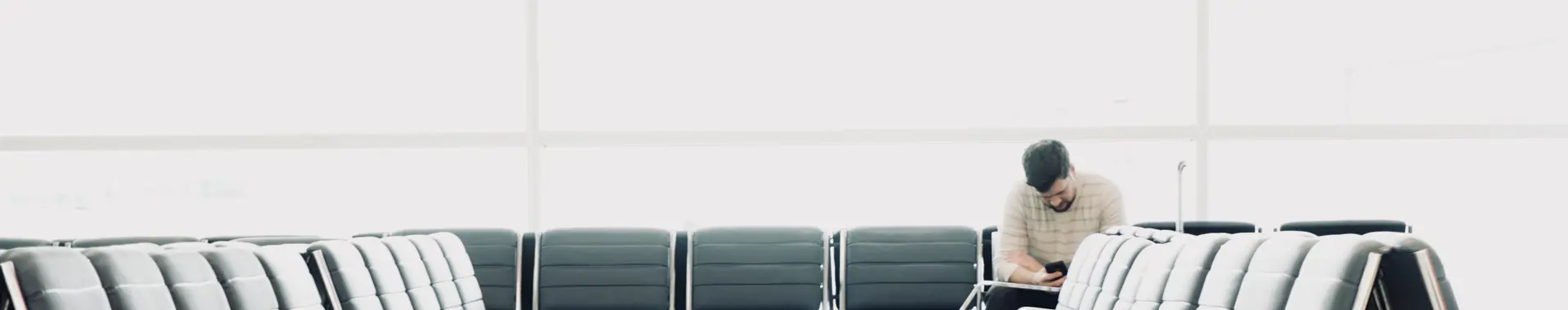 Man sitting in departures terminal 
