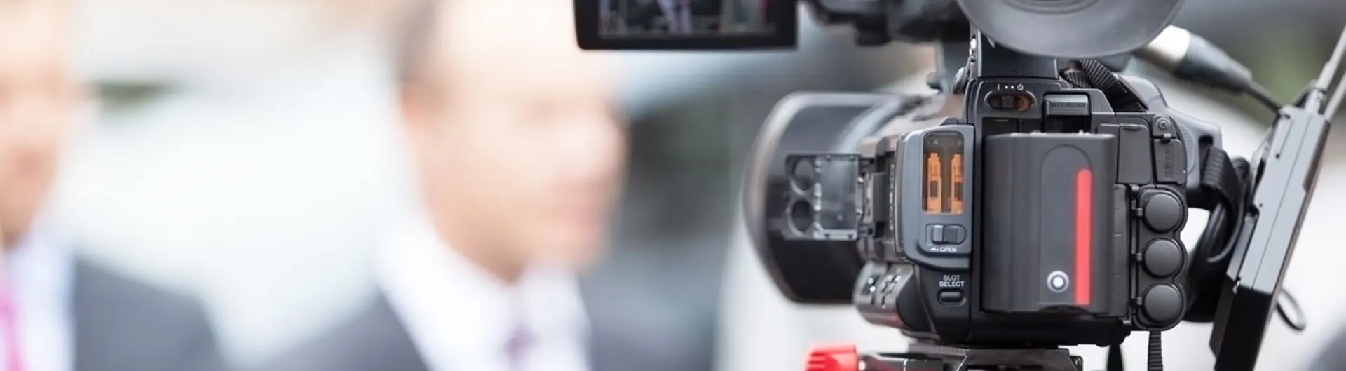 Film camera filming people