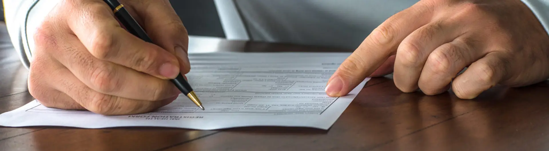 Person writing on piece of paper