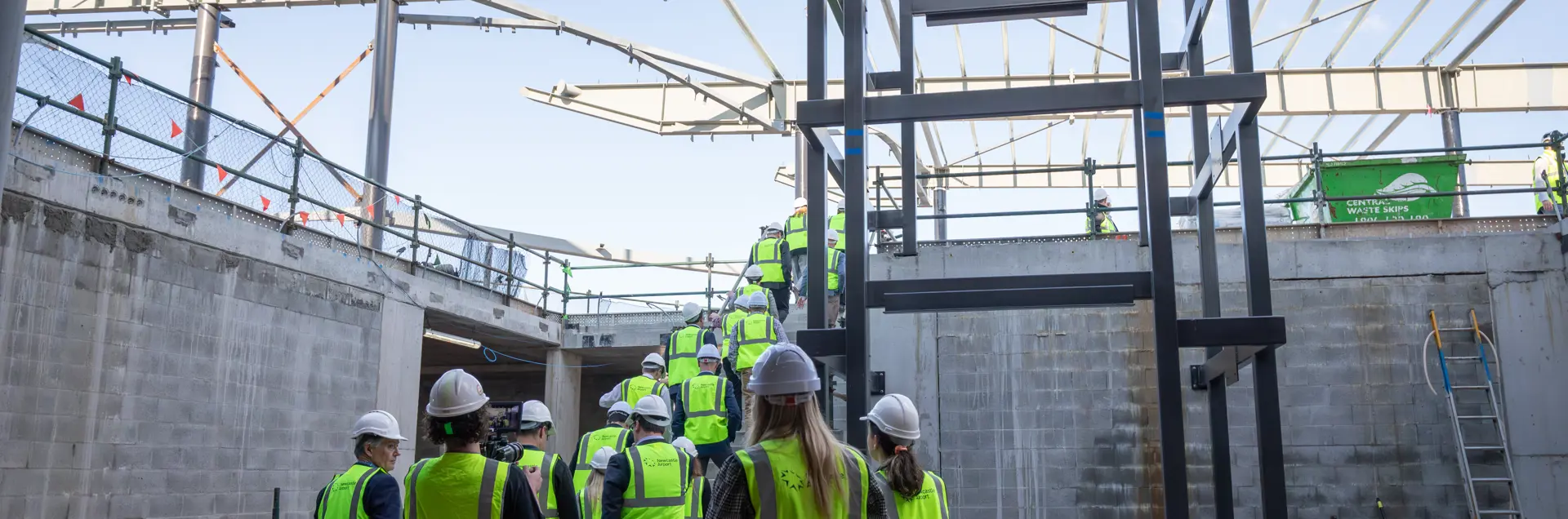 Newcastle Airport Staff, HJO members, News Crew and construction workers walking up stairs at Newcastle Airport construction site