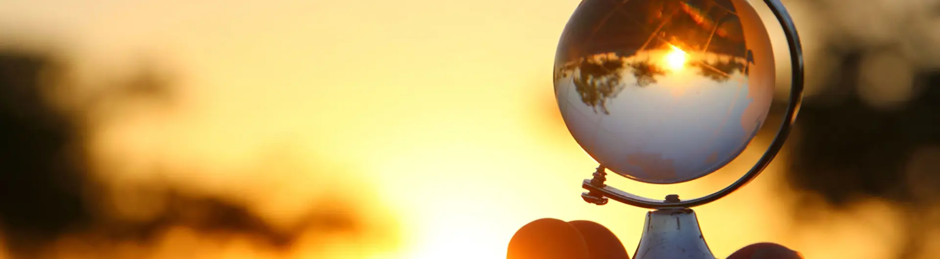 Person holding small globe 