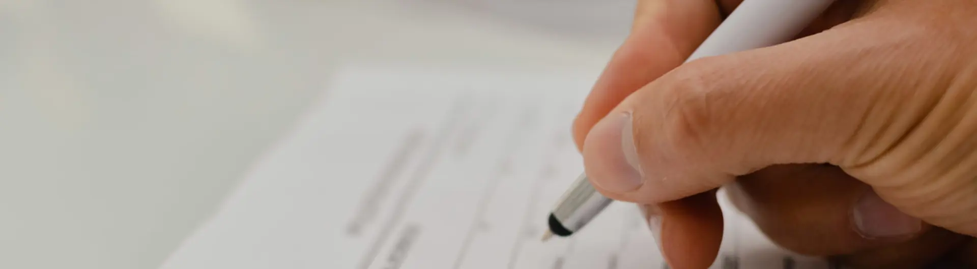 Person writing on piece of paper 