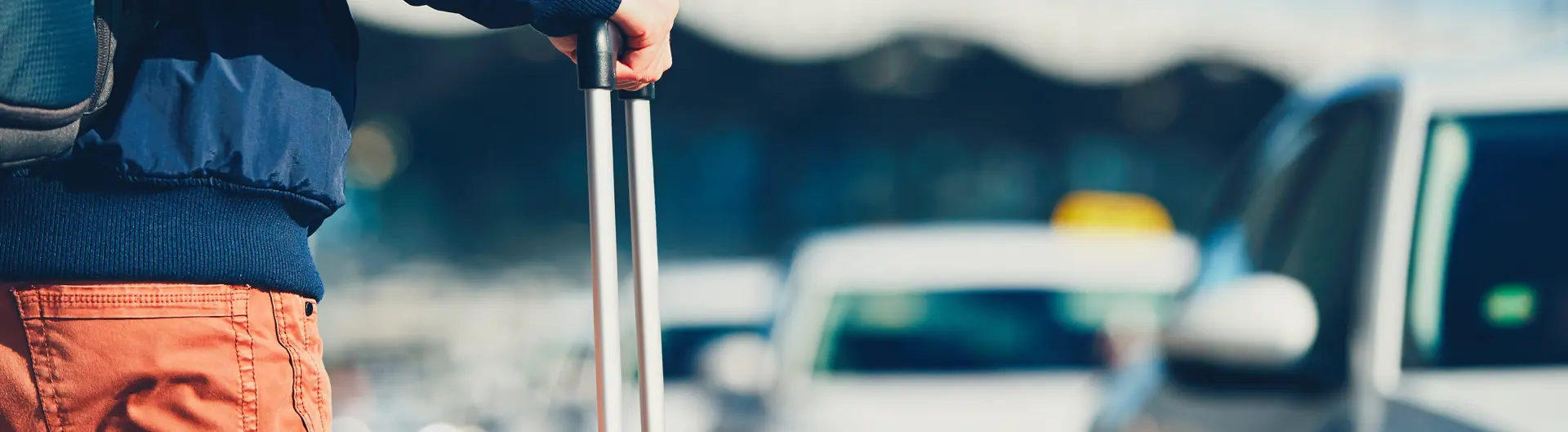 Man walking to car with luggage 